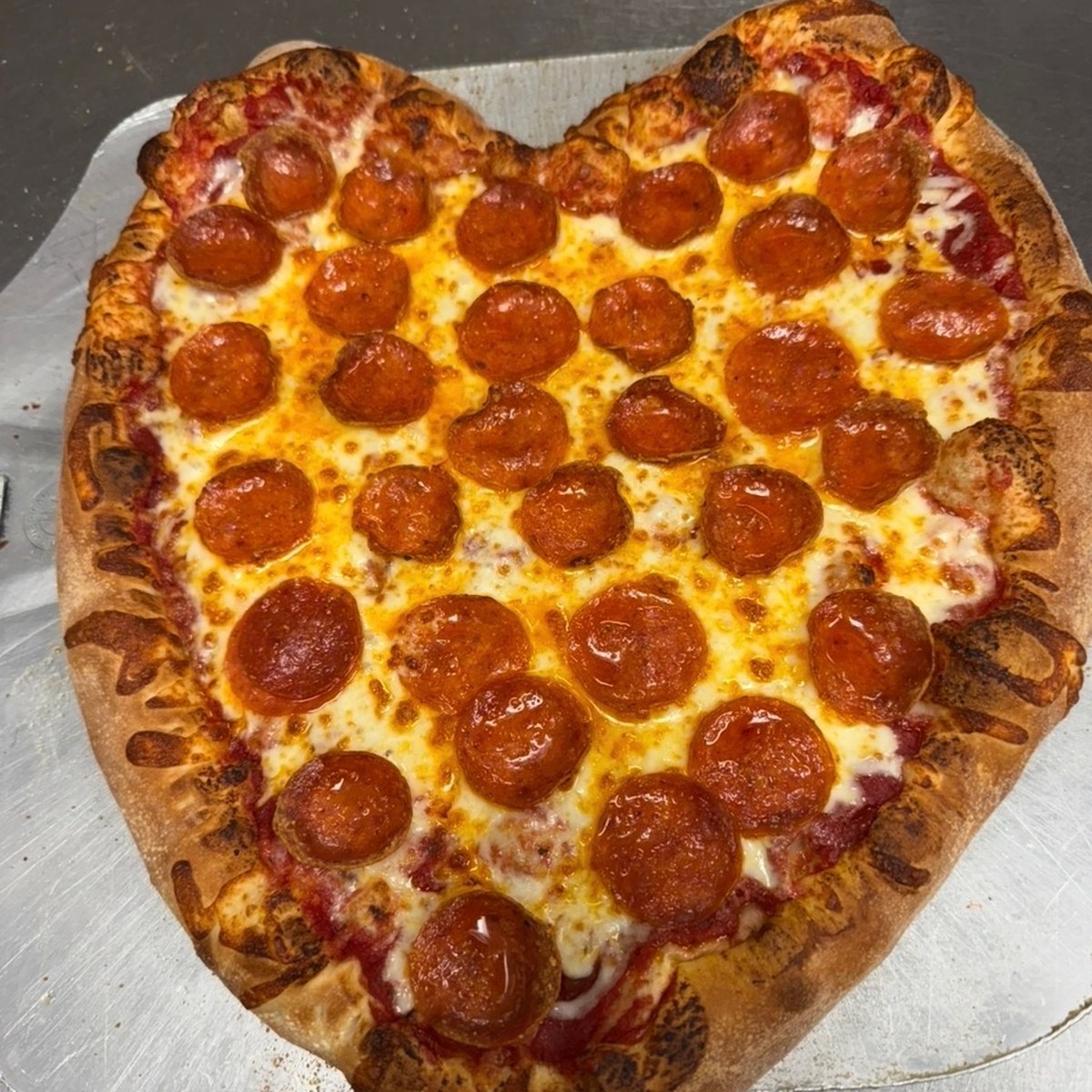 A large B.C. Pizza pepperoni pizza, fresh from the oven.