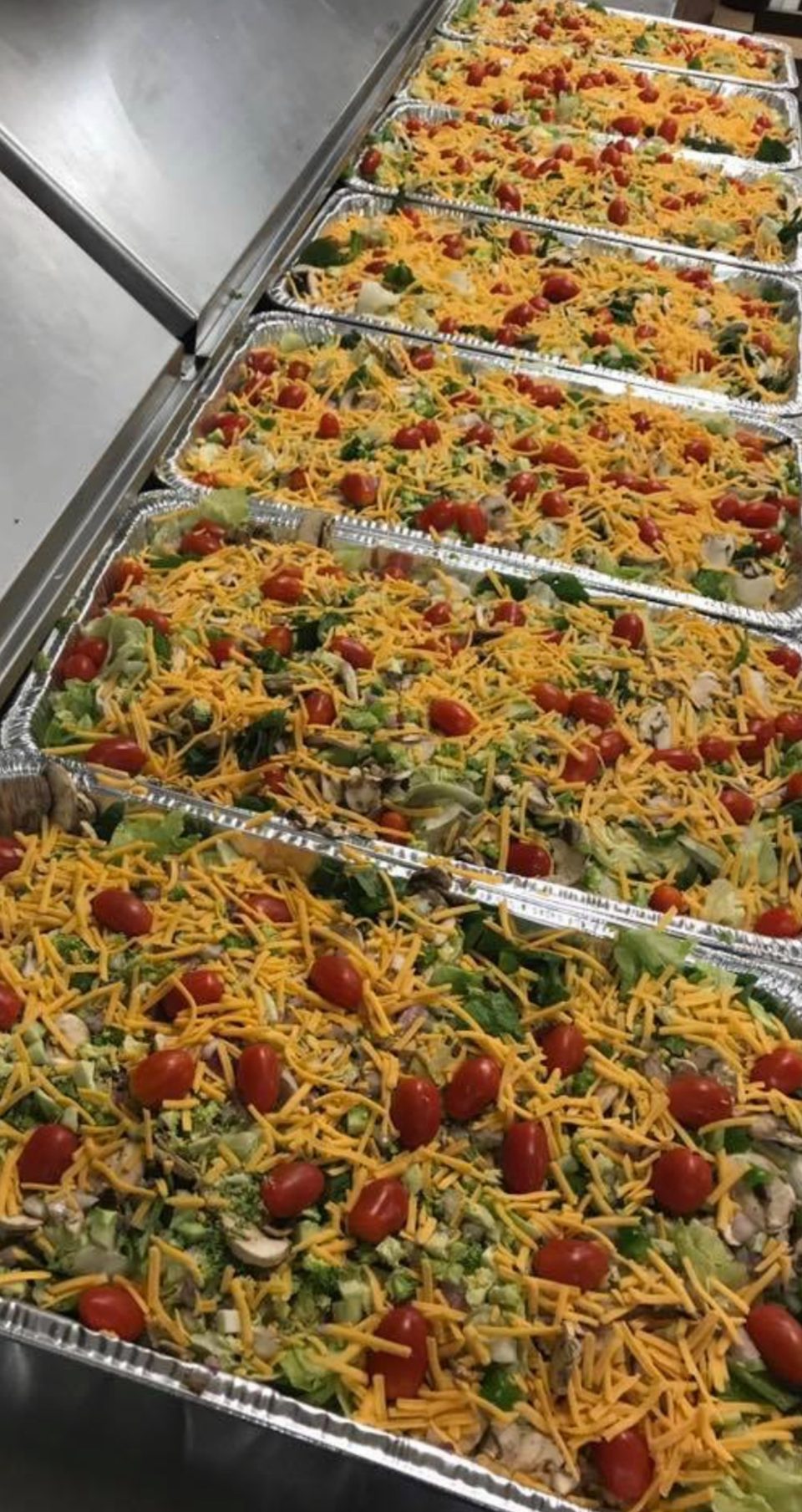 A row of party salad trays.